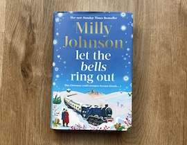 blue book with image of t train on with two people to the left